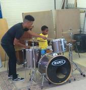 Drum tutor helping his student